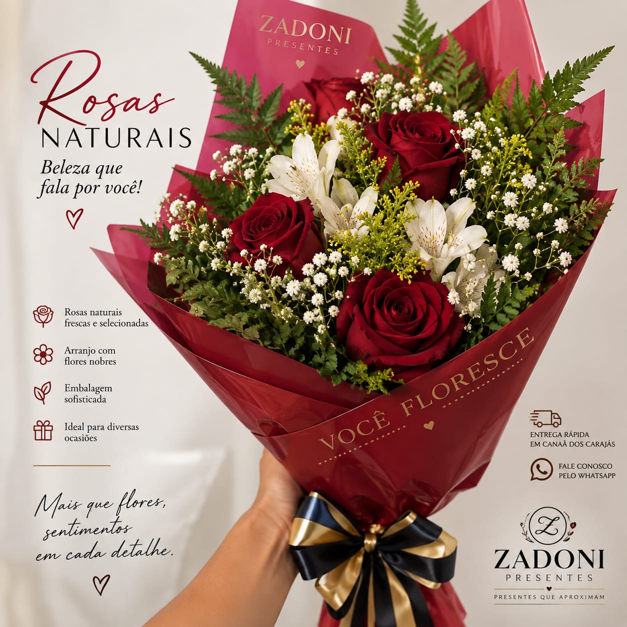 Buquê de rosas naturais vermelhas com flores brancas, folhagens, embalagem vermelha e laço preto e dourado